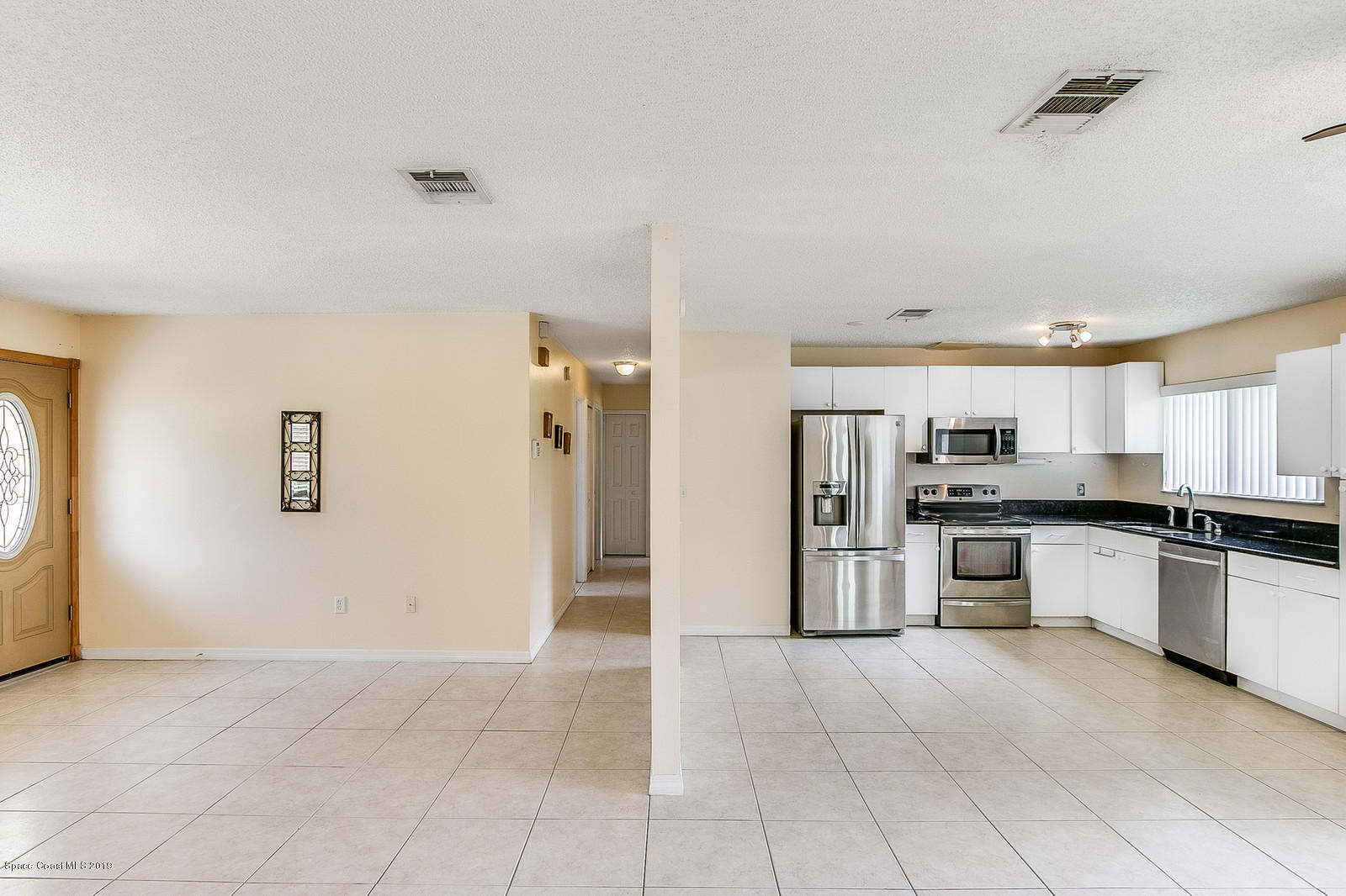 639 Furth Road Northwest Palm Bay, FL 32907 - Photo 10 of 22 a kitchen with stainless steel appliances granite countertop a refrigerator and a stove top oven