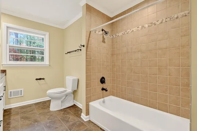 a bathroom with a toilet a sink and bathtub