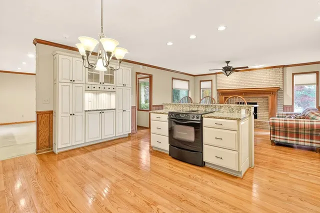 a kitchen with stainless steel appliances a stove refrigerator and cabinets