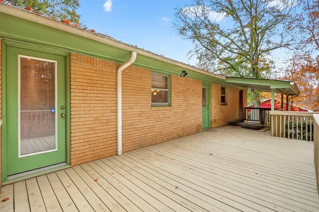 a view of a house with wooden deck
