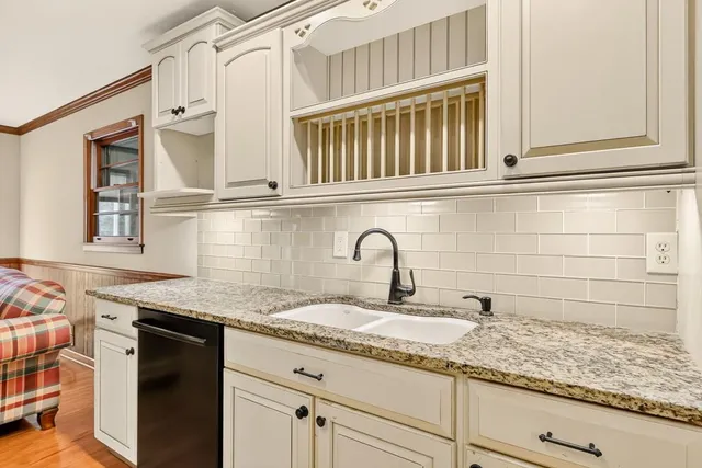 a kitchen with stainless steel appliances granite countertop a sink and cabinets