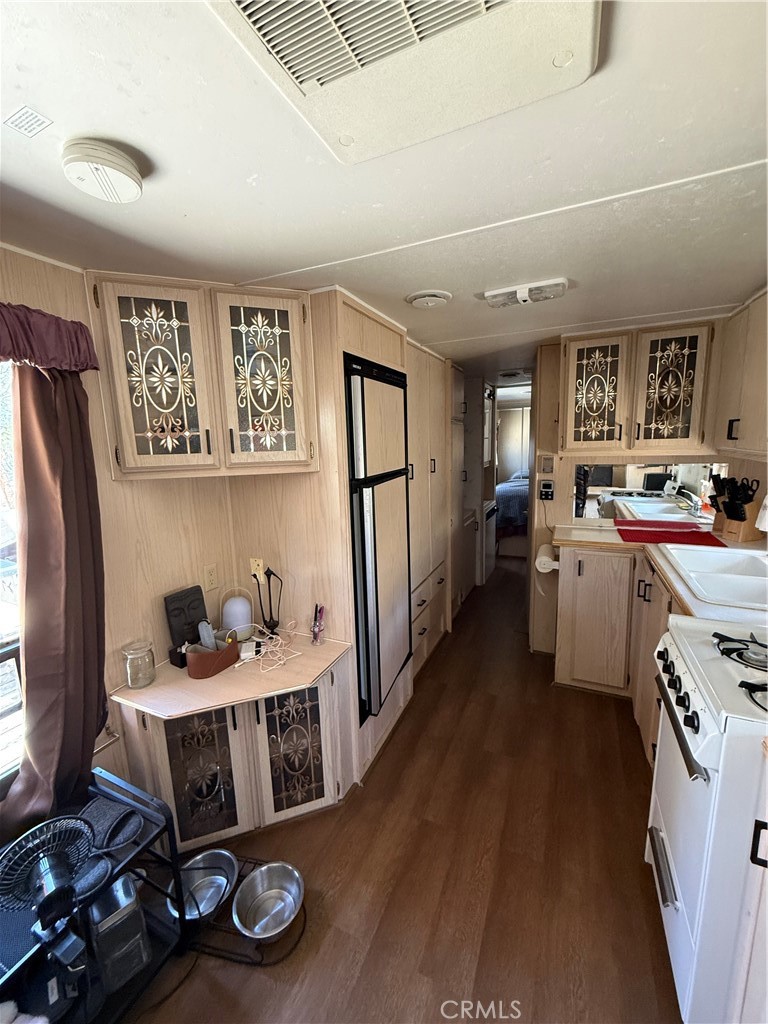 96484 Kennedy Meadow Road Inyokern, CA 93527 - Photo 36 of 42 a kitchen with a refrigerator and a stove top oven