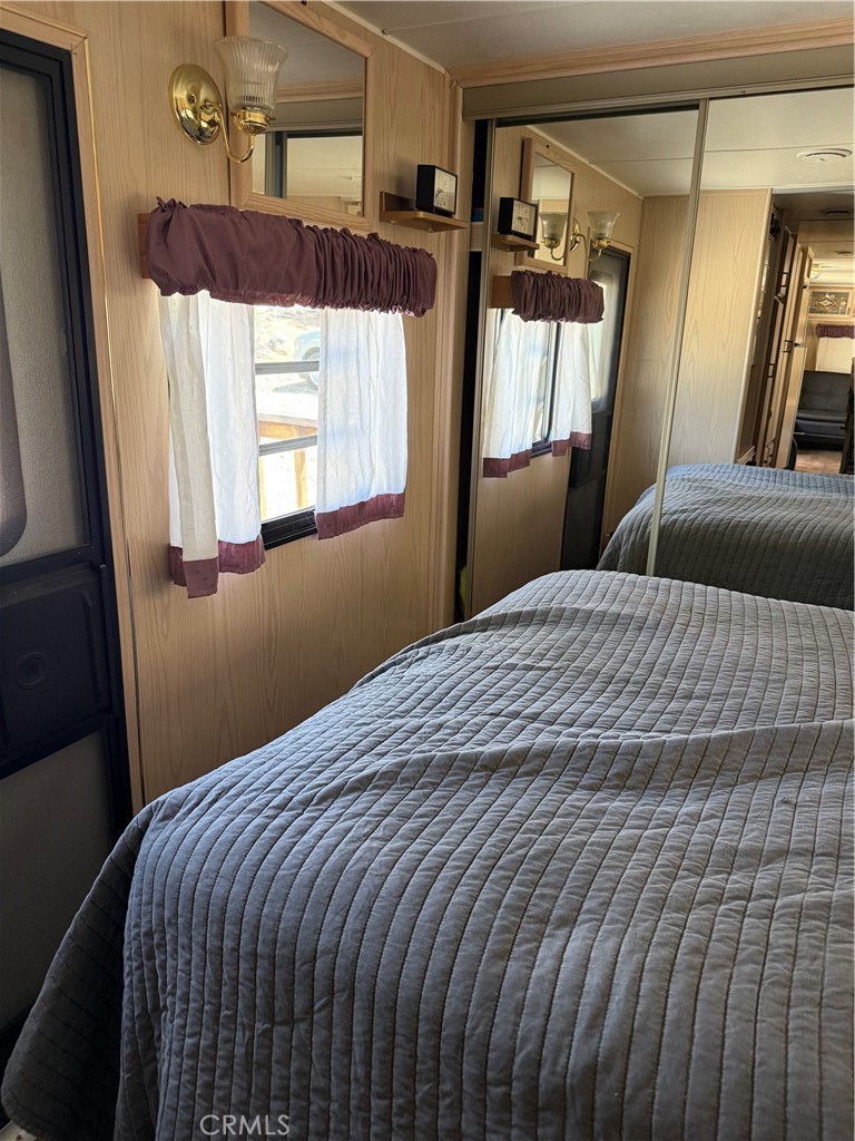96484 Kennedy Meadow Road Inyokern, CA 93527 - Photo 41 of 42 a bedroom with a bed and a mirror