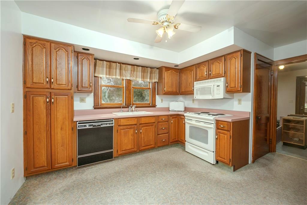 210 Cook Road Belle Vernon, PA 15012 - Photo 6 of 15 a kitchen with stainless steel appliances granite countertop a stove top oven a sink dishwasher a refrigerator and cabinets with wooden floor