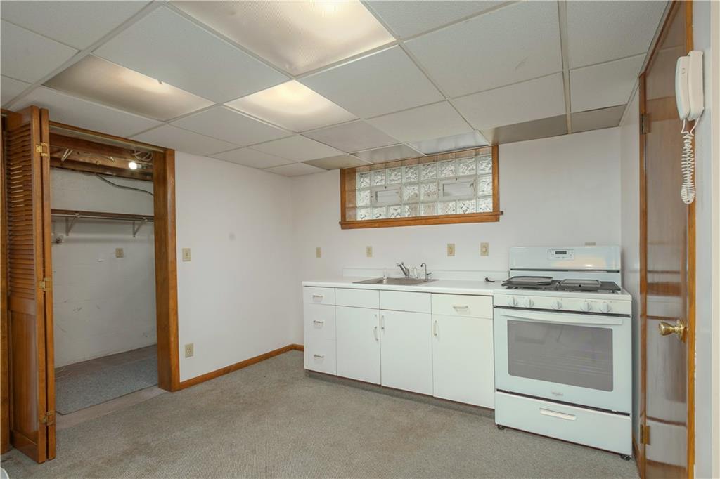 210 Cook Road Belle Vernon, PA 15012 - Photo 7 of 15 a view of cabinets a sink and a stove in a room