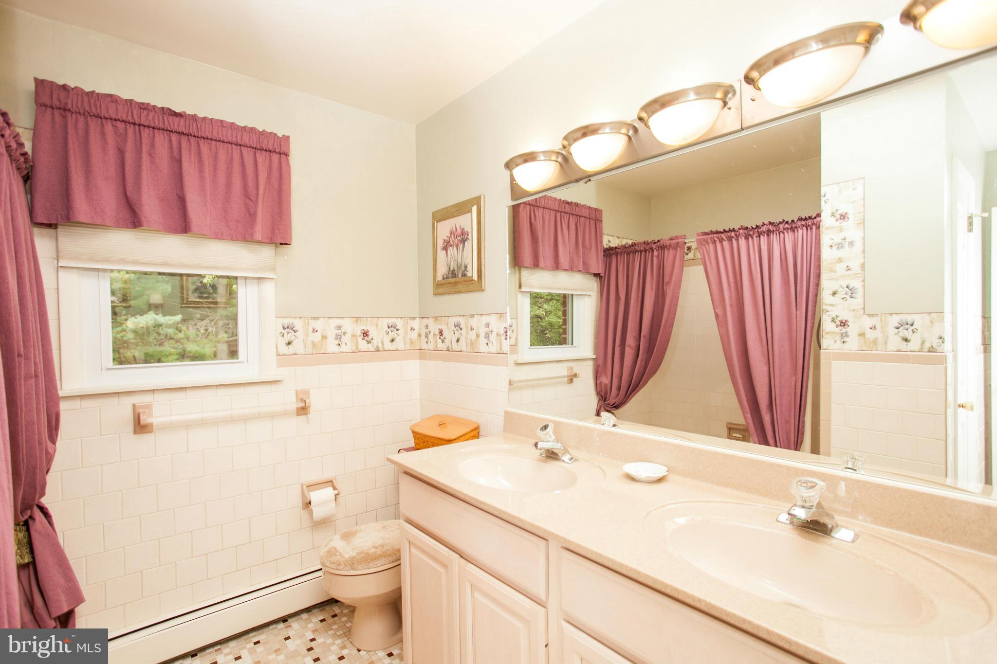 9914 Marilynn Road Perry Hall, MD 21128 - Photo 14 of 25 a bathroom with a sink mirror vanity and toilet
