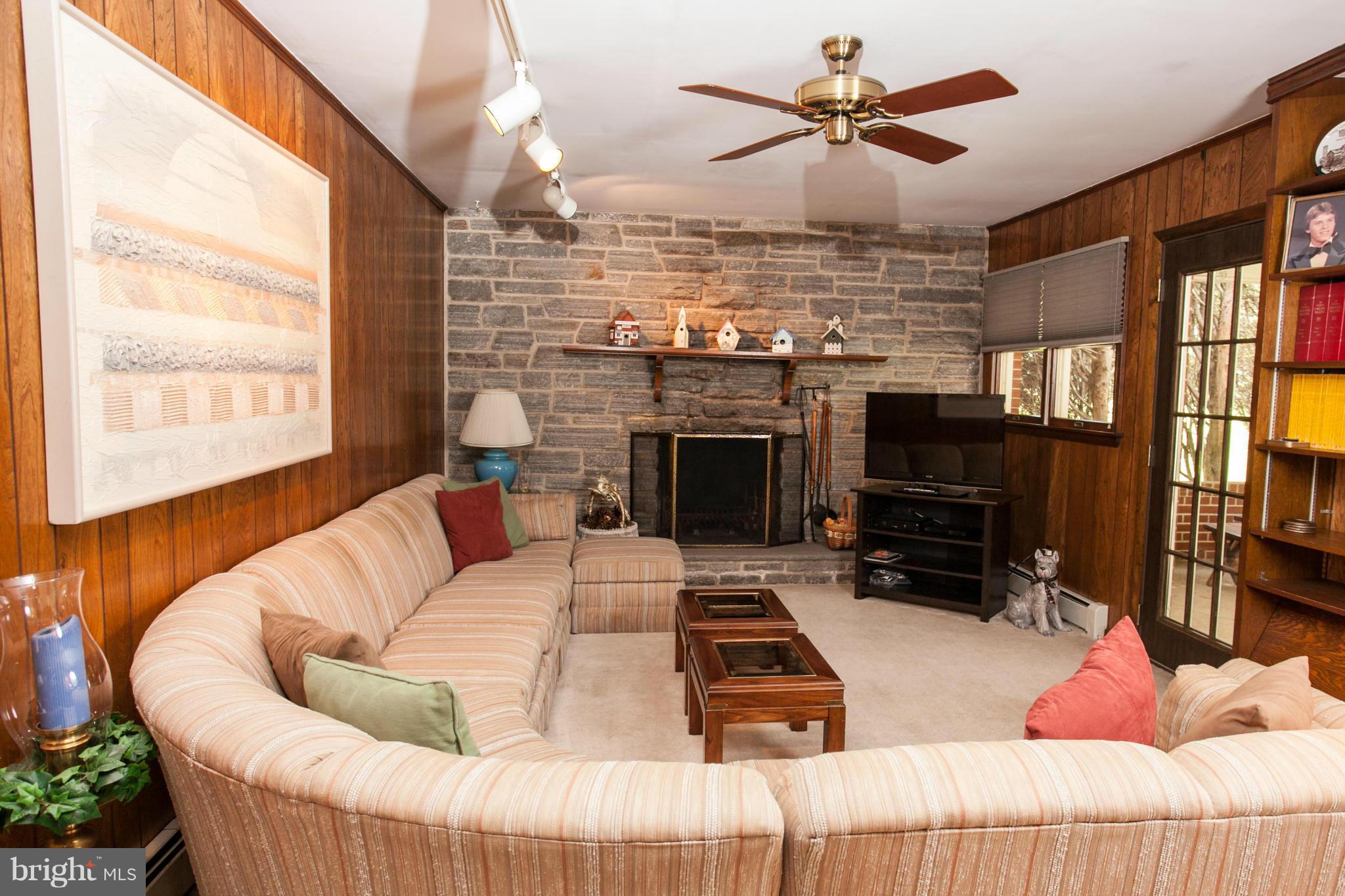 9914 Marilynn Road Perry Hall, MD 21128 - Photo 19 of 25 a living room with furniture a flat screen tv and a fireplace