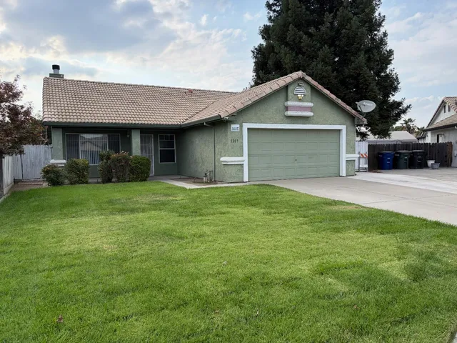 a front view of a house with yard and green space