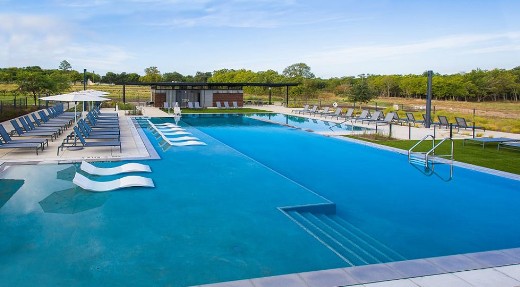 9109 The Ravine Way Austin, TX 78744 - Photo 7 of 13 a view of a swimming pool with lounge chair