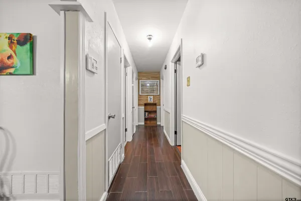 a view of hallway with wooden floor