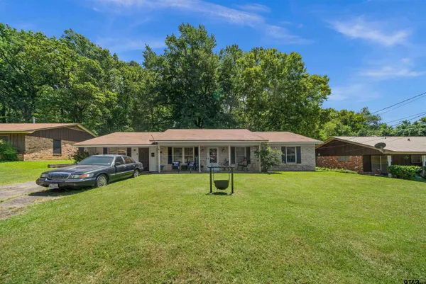 a kitchen with granite countertop stainless steel appliances and wooden floors