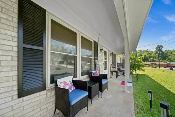 a kitchen with stainless steel appliances granite countertop a sink a stove and a wooden cabinets