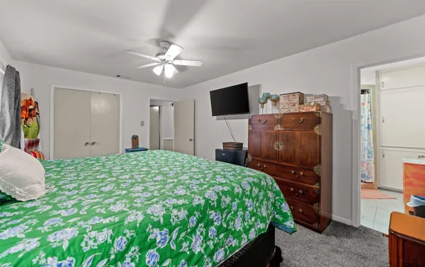 a bedroom with a bed and a flat screen tv