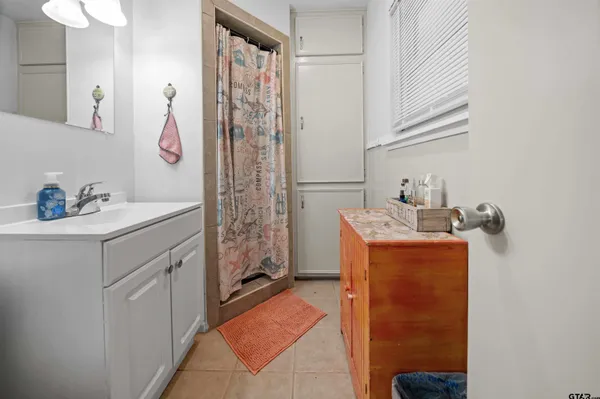 a bathroom with a sink a toilet and mirror