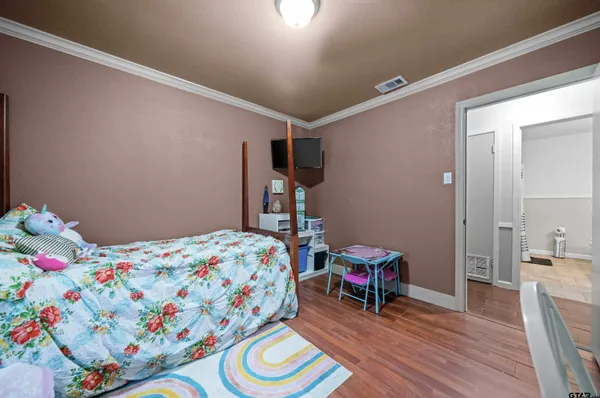 a bedroom with a bed and a chandelier