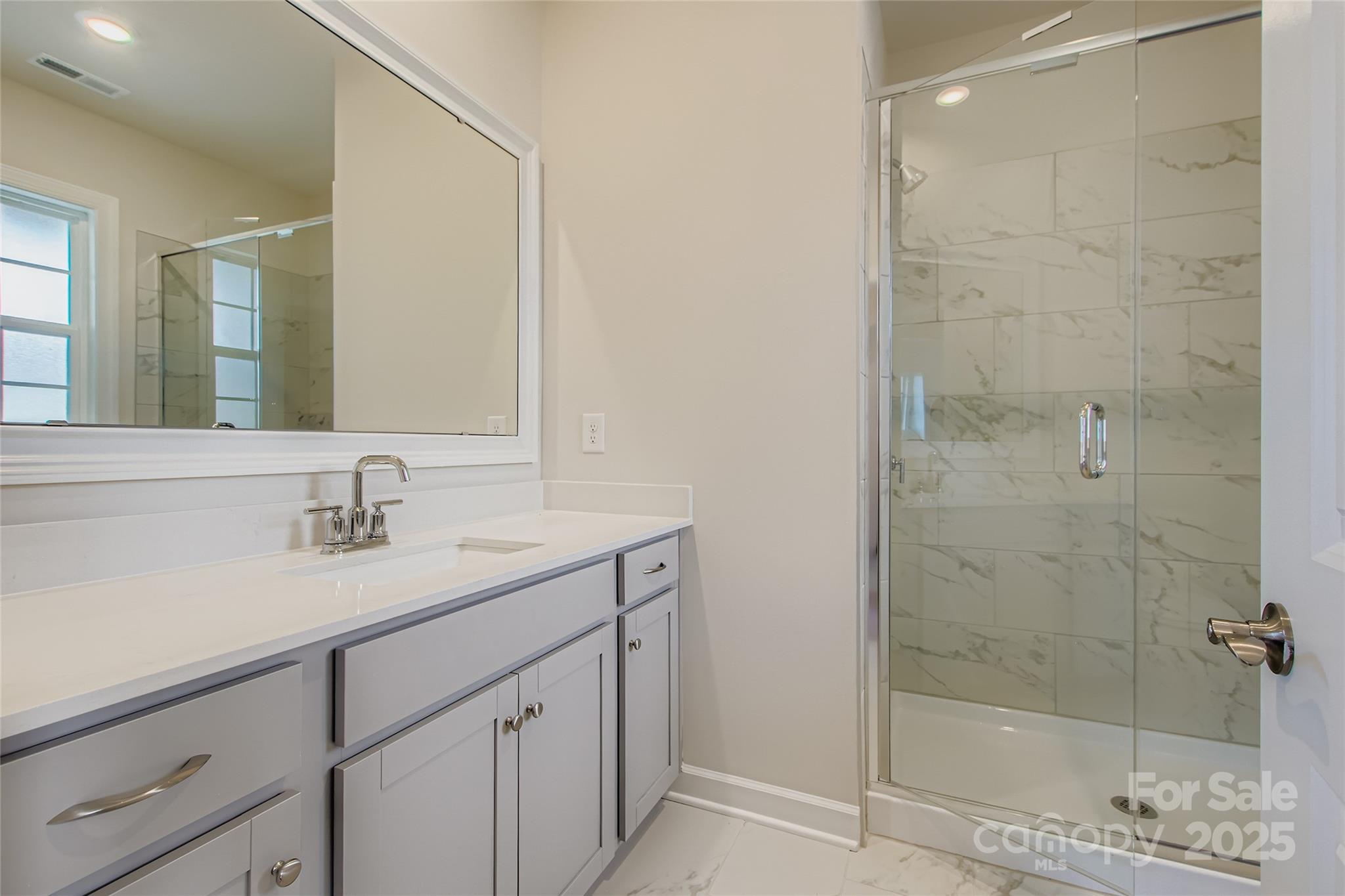 2255 Moon Crst Road, Unit 137 Lancaster, SC 29720 - Photo 13 of 16 a bathroom with a shower sink and mirror
