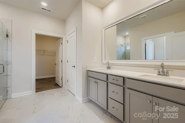 a bathroom with a double vanity sink and mirror