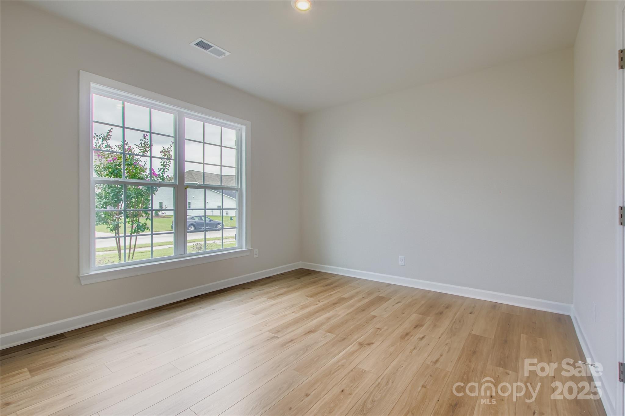 2255 Moon Crst Road, Unit 137 Lancaster, SC 29720 - Photo 10 of 16 an empty room with wooden floor and windows