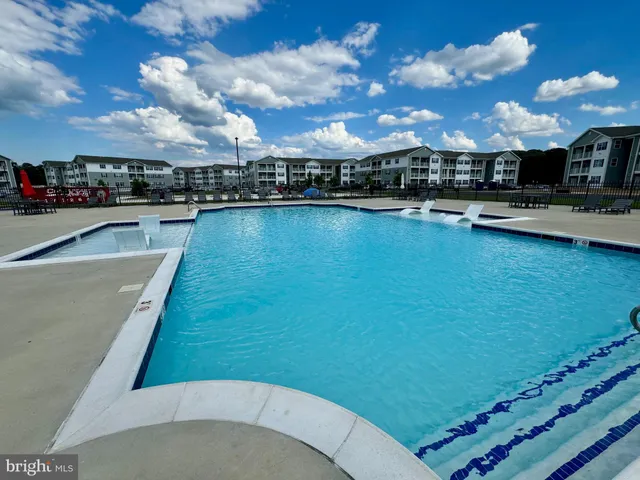 a view of a swimming pool with an outdoor seating
