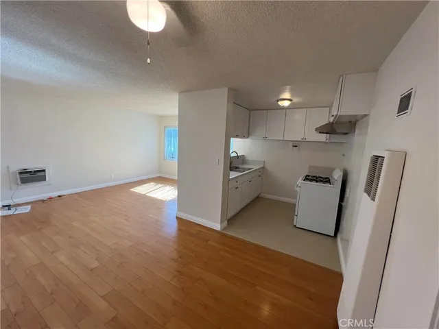 a view of kitchen with refrigerator and window