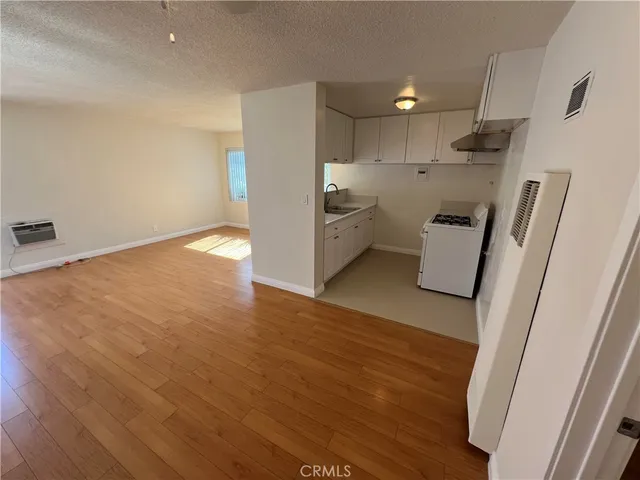 a view of a kitchen with a sink and a refrigerator
