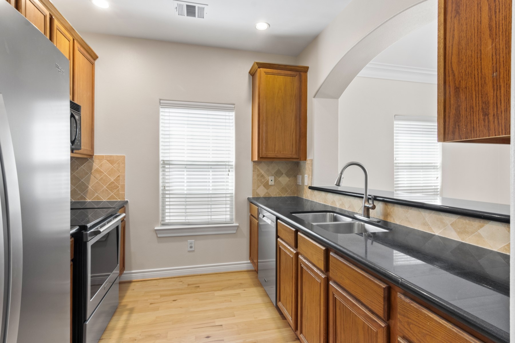2917 Clinton Drive Houston, TX 77020 - Photo 16 of 24 a kitchen that has a sink cabinets appliances and a window