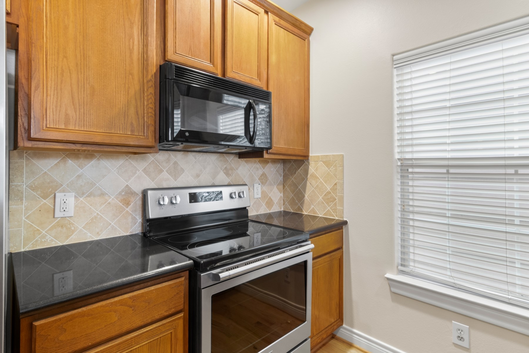 2917 Clinton Drive Houston, TX 77020 - Photo 17 of 24 a kitchen with a stove microwave and cabinets