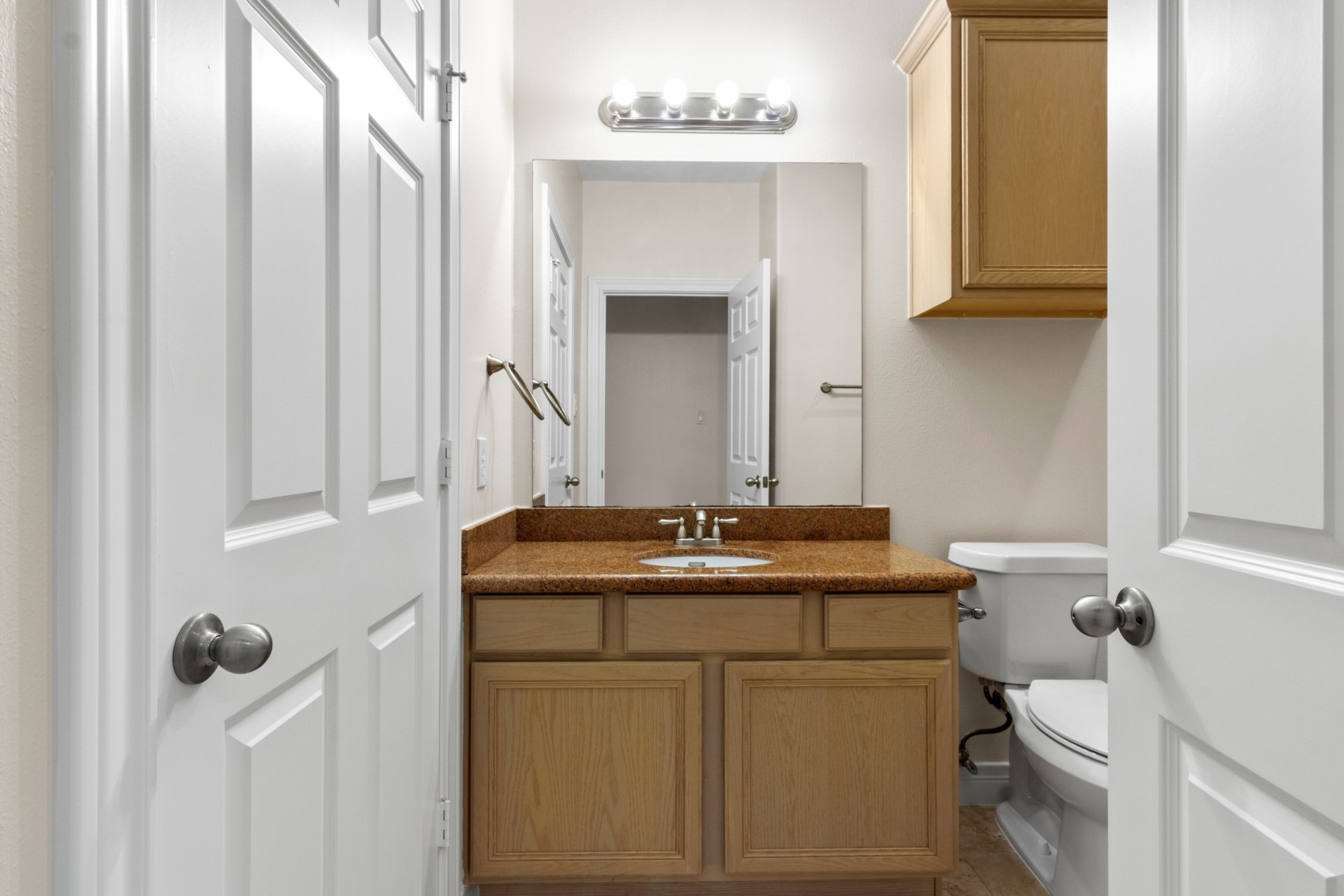 2917 Clinton Drive Houston, TX 77020 - Photo 21 of 24 a bathroom with a granite countertop sink a toilet and a mirror