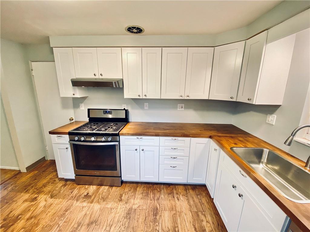 206 Streets Run Road Pittsburgh, PA 15236 - Photo 6 of 22 Beautiful newer kitchen with white cabinetry and butcher block counter tops.