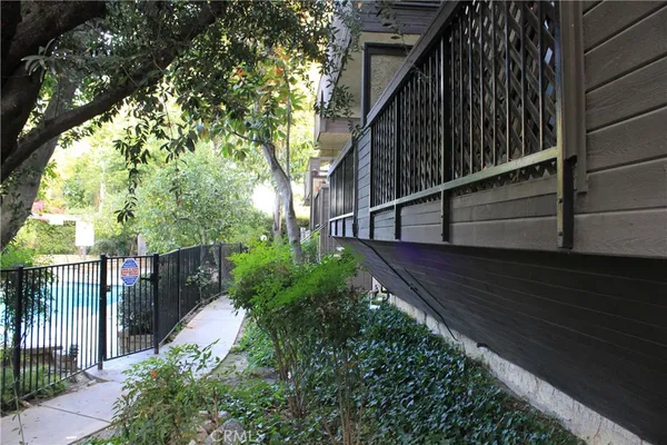 a pathway of a house with a yard