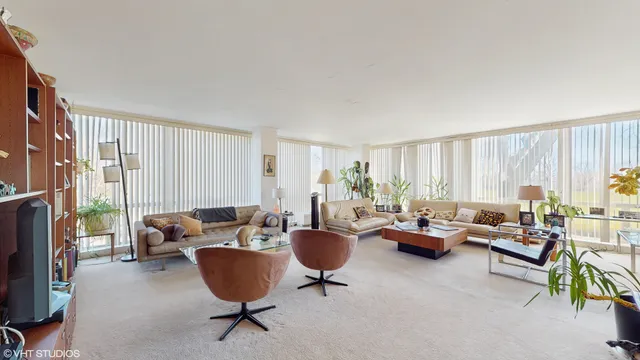 a living room with furniture a fireplace and a window