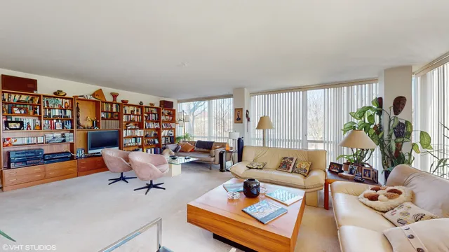 a living room with furniture and a book shelf