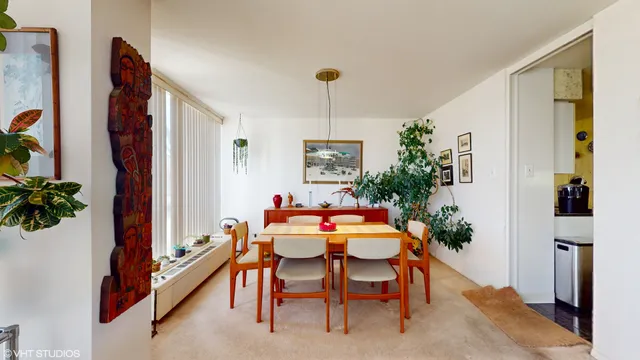 a dining room with furniture and window