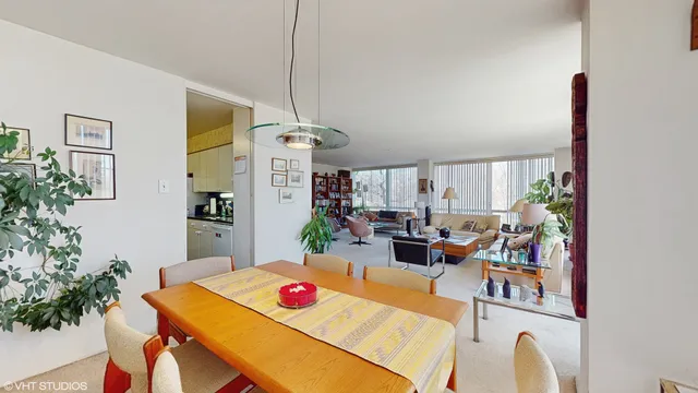 a view of a dining room with furniture and a potted plant