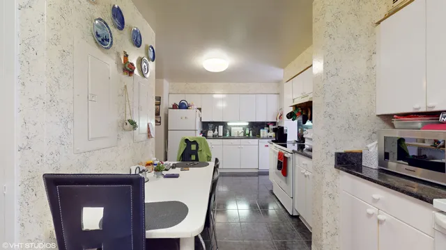 a kitchen with granite countertop a sink a counter space and appliances