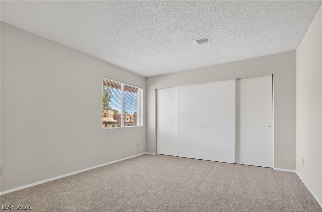 2241 Highpointe Drive, Unit 101 Laughlin, NV 89029 - Photo 19 of 23 This airy bedroom offers a comfortable retreat with ample storage and natural light.