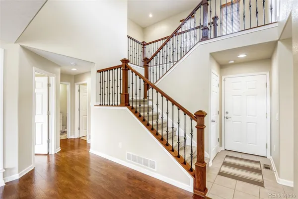 a view of staircase with lots of frames and white walls