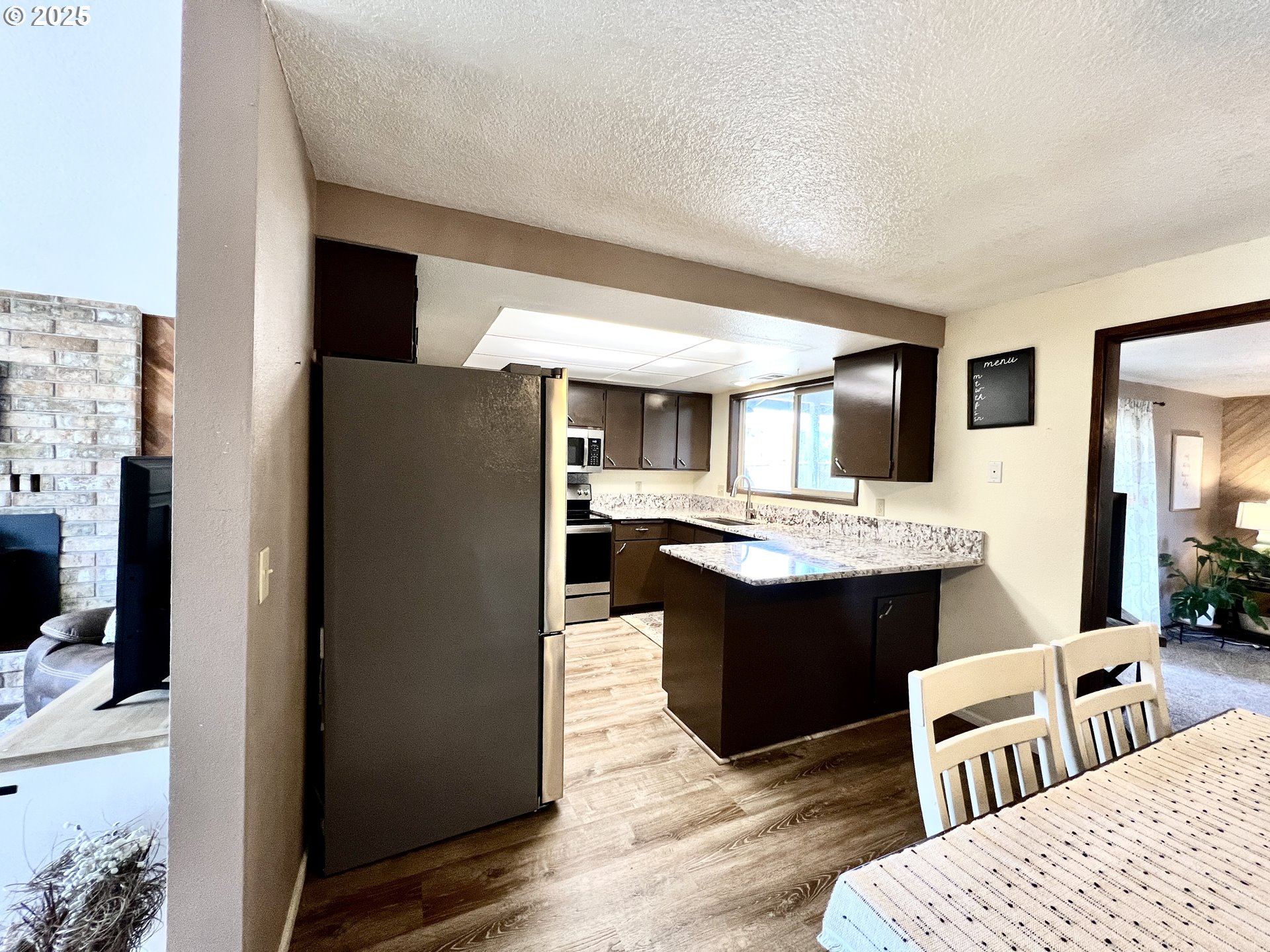 554 67th Street Springfield, OR 97478 - Photo 9 of 32 a kitchen with a sink refrigerator and dining table