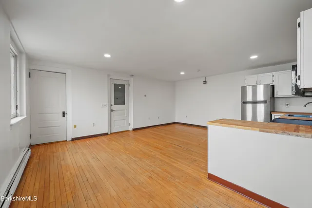 a view of a kitchen with wooden floor and a sink