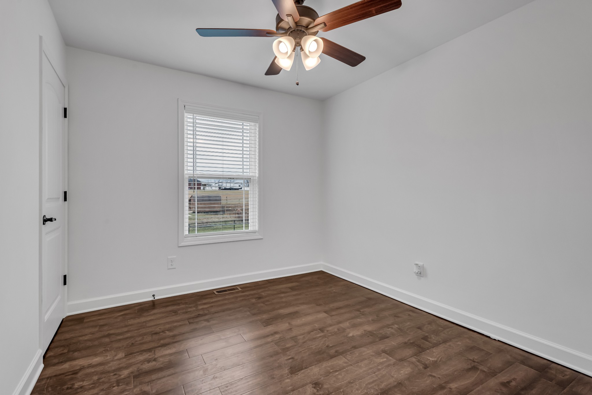 433 Pruett Road Dickson, TN 37055 - Photo 16 of 24 a view of an empty room with window and wooden floor
