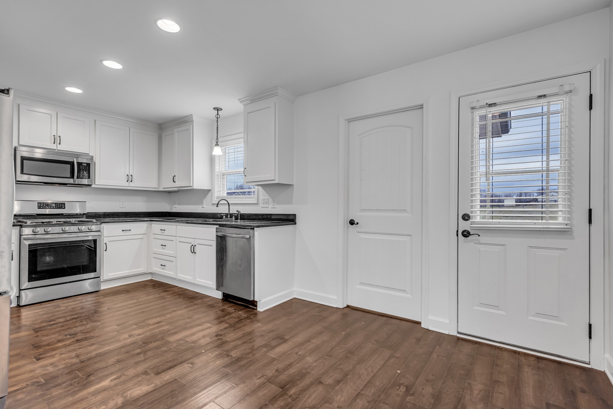 433 Pruett Road Dickson, TN 37055 - Photo 7 of 24 a kitchen with granite countertop a stove top oven and cabinets