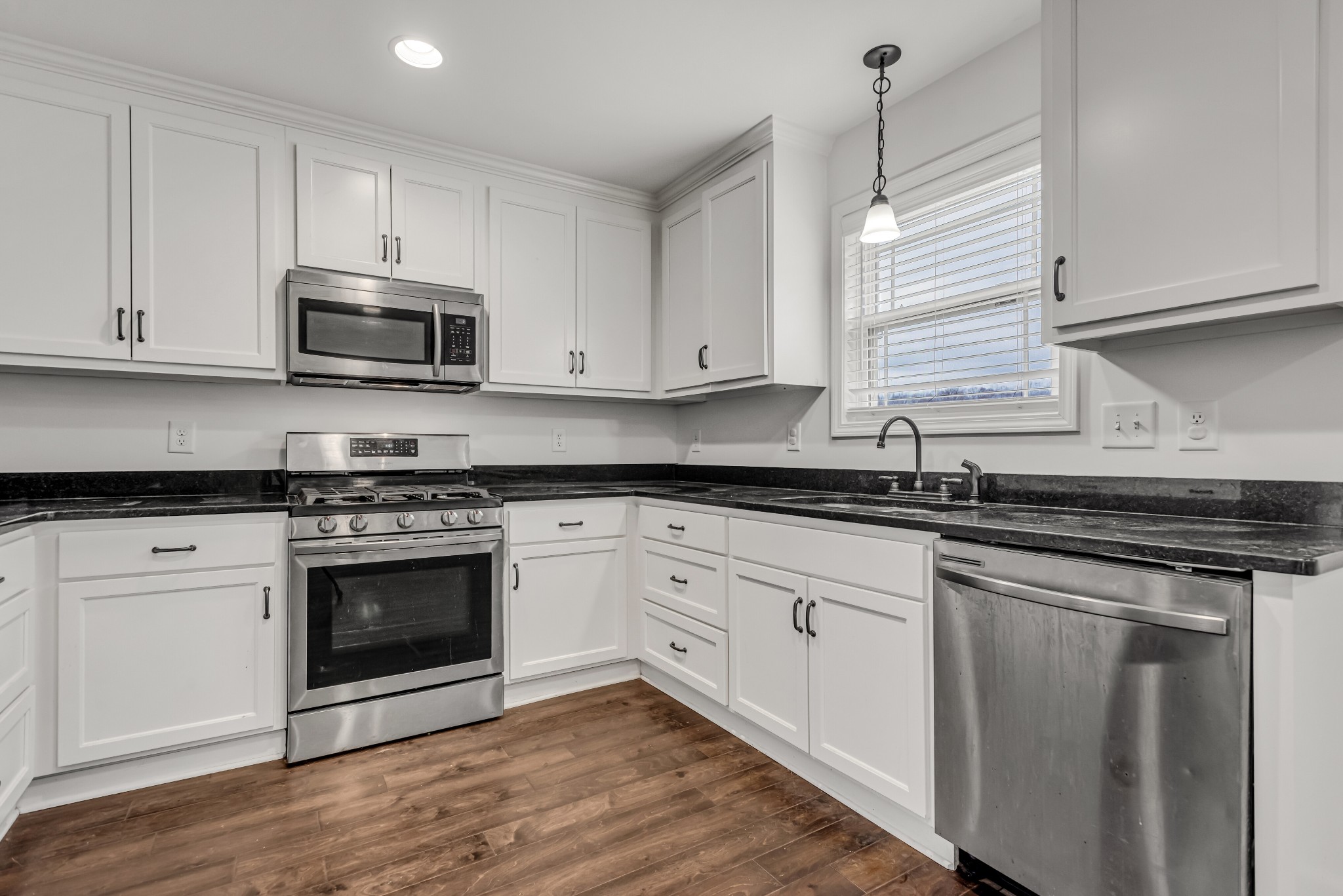 433 Pruett Road Dickson, TN 37055 - Photo 9 of 24 a kitchen with granite countertop white cabinets and appliances