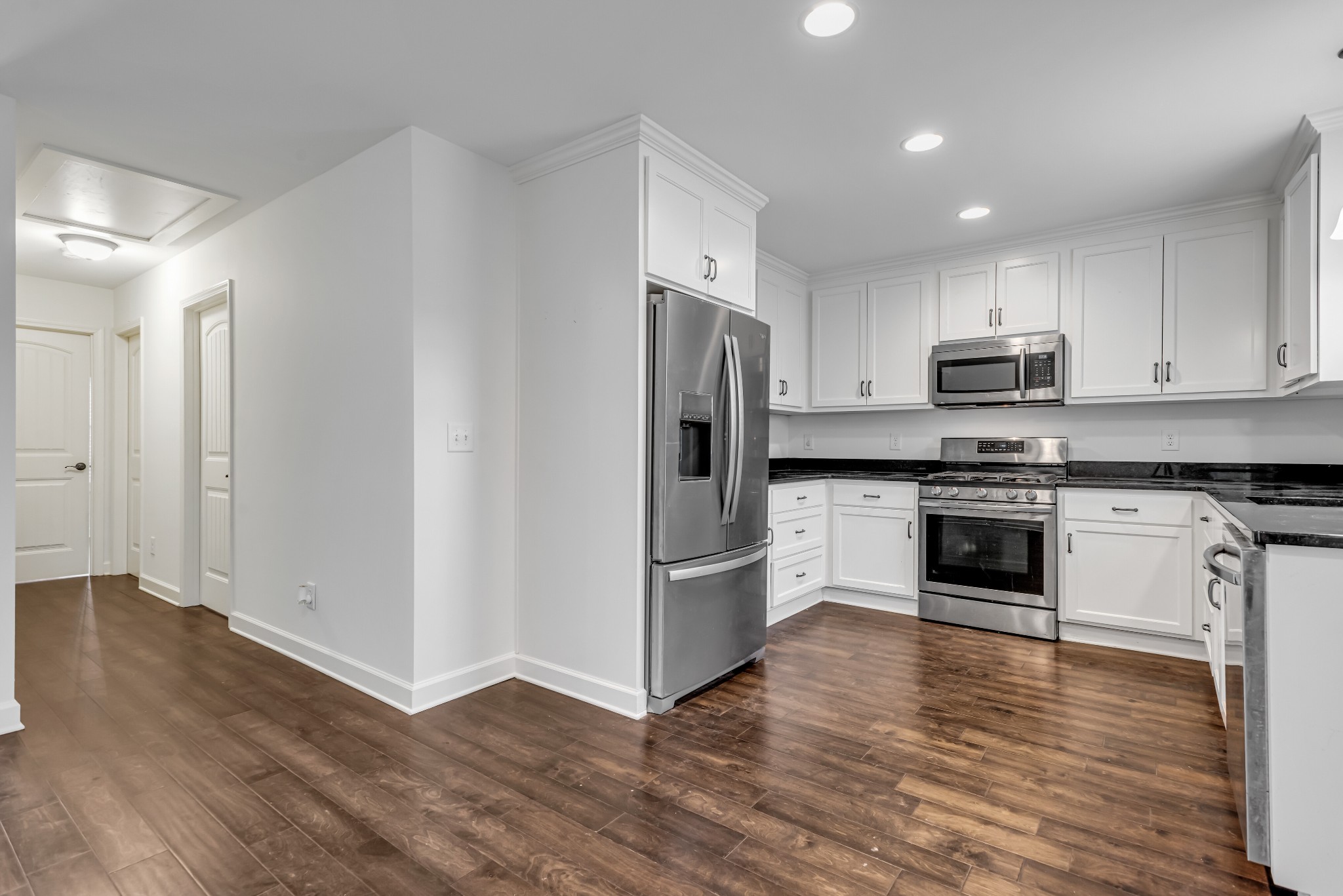 433 Pruett Road Dickson, TN 37055 - Photo 10 of 24 a kitchen with granite countertop white cabinets and stainless steel appliances