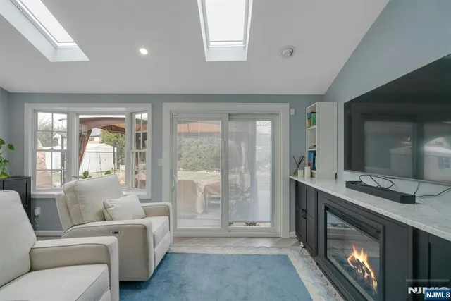 a living room with furniture and a floor to ceiling window