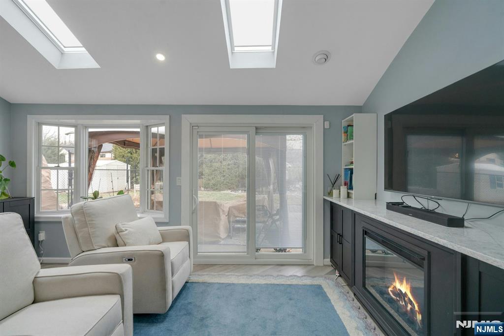 111 Crain Road Paramus, NJ 07652 - Photo 11 of 30 a living room with furniture a large window and a fireplace