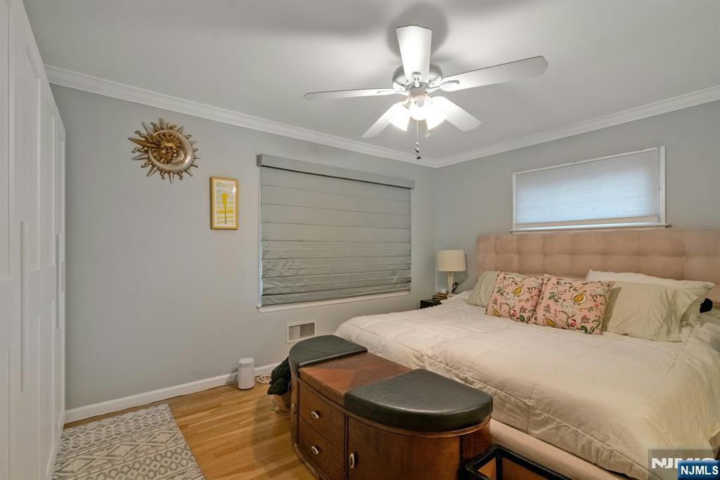 111 Crain Road Paramus, NJ 07652 - Photo 14 of 30 a bedroom with a bed and a chandelier