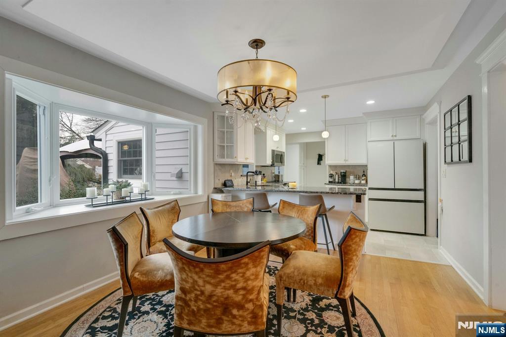 111 Crain Road Paramus, NJ 07652 - Photo 7 of 30 a dining room with furniture a chandelier and wooden floor