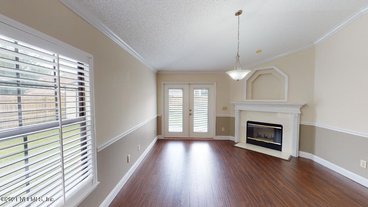 3130 Mountain Ash Road South Jacksonville, FL 32223 - Photo 12 of 60 a view of a livingroom with wooden floor a fireplace and windows