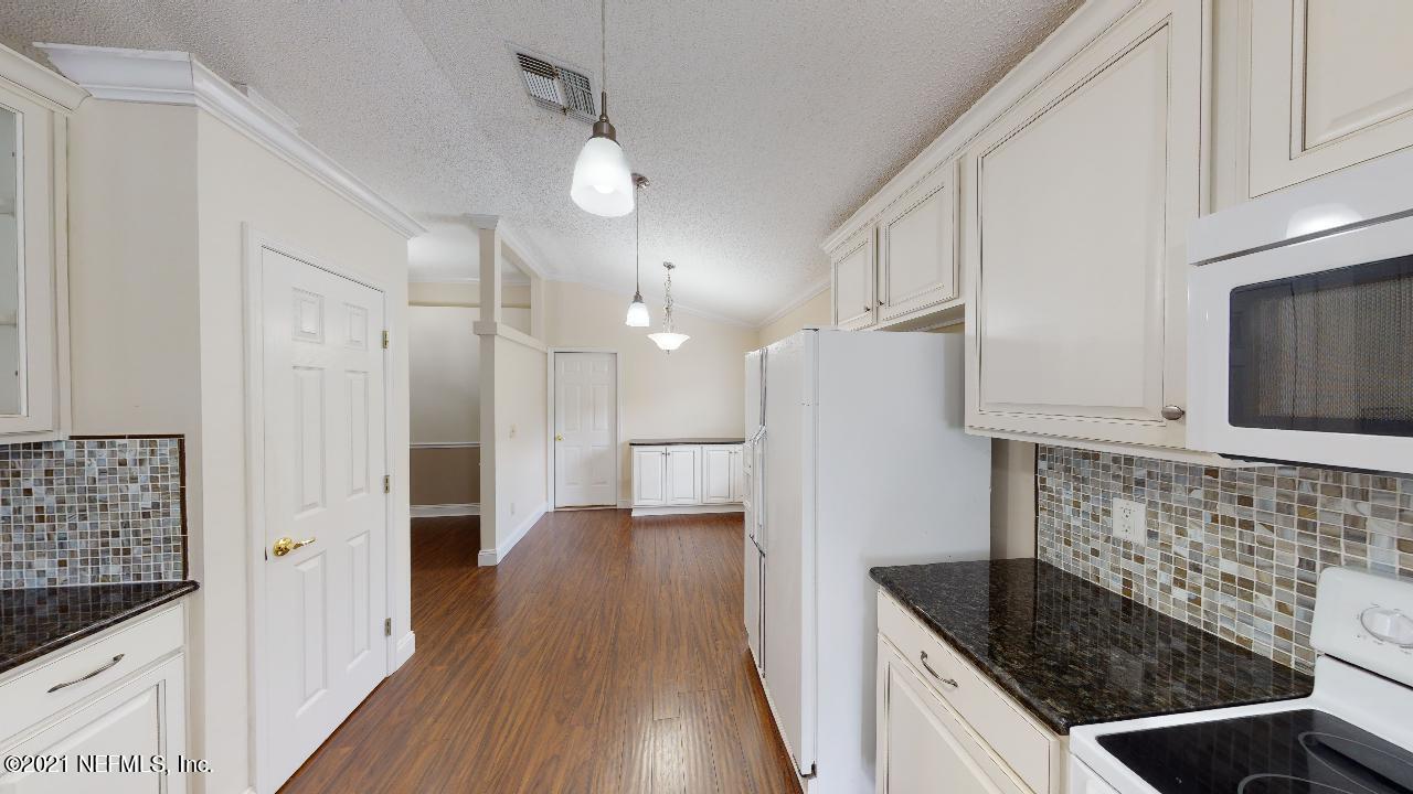 3130 Mountain Ash Road South Jacksonville, FL 32223 - Photo 15 of 60 a kitchen with stainless steel appliances granite countertop a sink stove and refrigerator