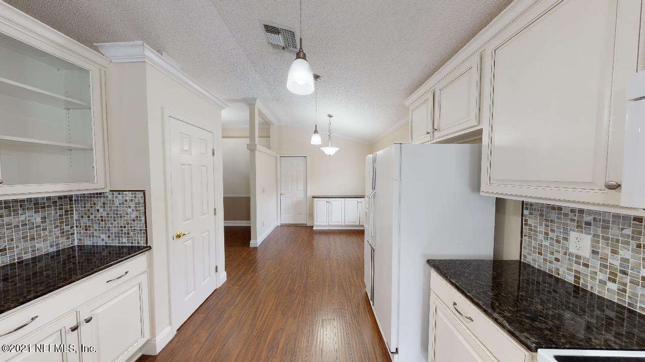 3130 Mountain Ash Road South Jacksonville, FL 32223 - Photo 16 of 60 a kitchen with granite countertop a sink stove and refrigerator